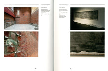 Load image into Gallery viewer, The inside of the book. The left page features two photographs. The first shows a room with red brick walls and a concrete floor. The second shows a close-up of the walls, where you can see that instead of mortar between the bricks there are sticks of chalk. On the right page the first photo shows a dimly lit blackboard with chalk dust piled up beneath it. The second photo shows a close up of the partially-erased writing on the board.