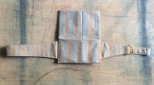 Load image into Gallery viewer, A waist bag in a striped grey and brown material with the straps spread out and the bag opened to display the interior of the bag, which is in the same fabric as the exterior.