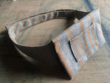 Load image into Gallery viewer, A waist bag in a striped grey and brown material standing on it's side.