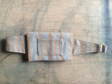 Load image into Gallery viewer, A waist bag in a striped grey and tan material. The straps are folded neatly behind the bag.