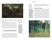 Load image into Gallery viewer, The inside of the book. The left page features a painting of a natural landscape with a rocky outcrop shaded by trees, followed by a paragraph of black text. The right page features a paragraph of black text followed by a painting of a natural scene with long grass and aspen trees. In the distance you can make out a thatched cottage. Both pages have a white background.
