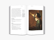 Load image into Gallery viewer, The inside of the book. The left page features several paragraphs of black text. The right page features a painting of a figure holding a palette and paintbrush painting on a canvas. The background of both pages is white.
